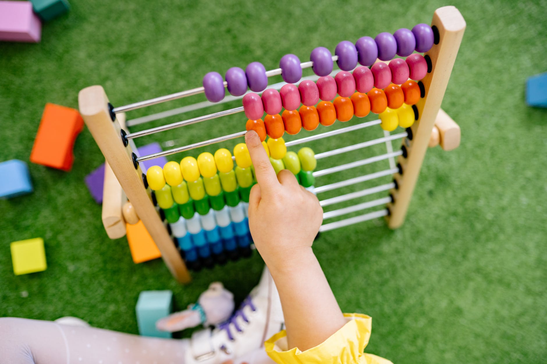 Mechanical Counting Devices with Examples 2 child playing with an abacus and learning to count